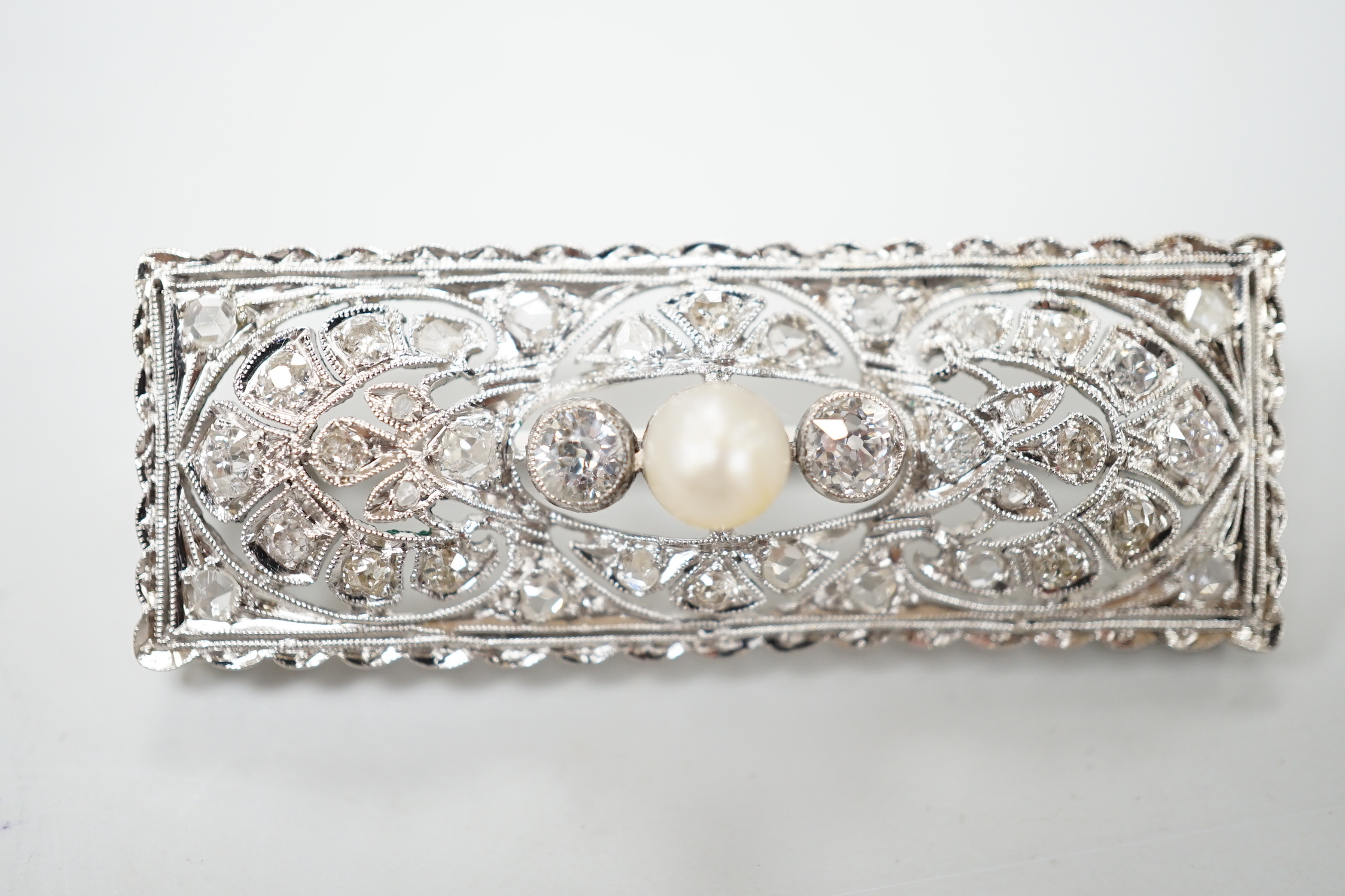 A 1920's white metal, pearl and diamond cluster set rectangular brooch, 43mm, gross weight 5.8 grams.